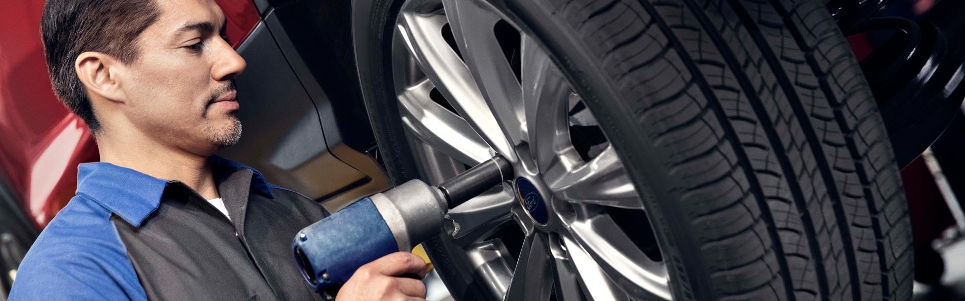 technician putting on a tire