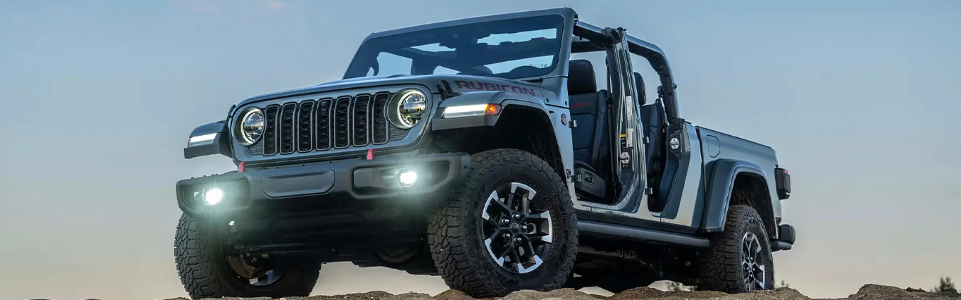 2026 Jeep Gladiator 4x4 pickup truck on rugged backcountry trail