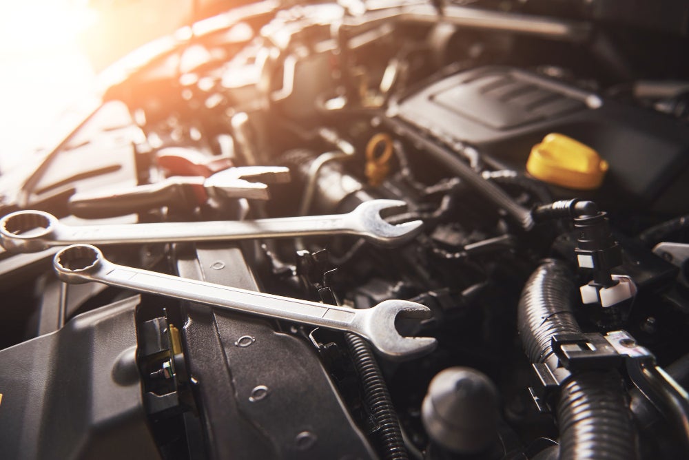 Factory-Trained Diesel Mechanic Working Under the Hood of a Heavy Duty Truck